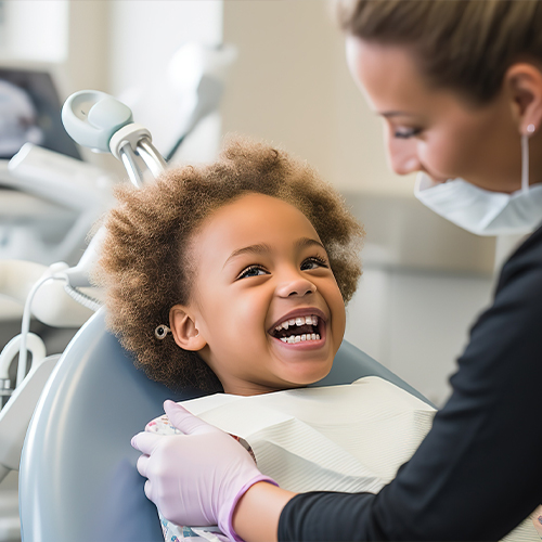 Child laughing in dental chair