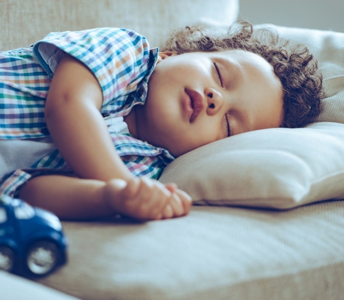 Young boy sleeping on couch