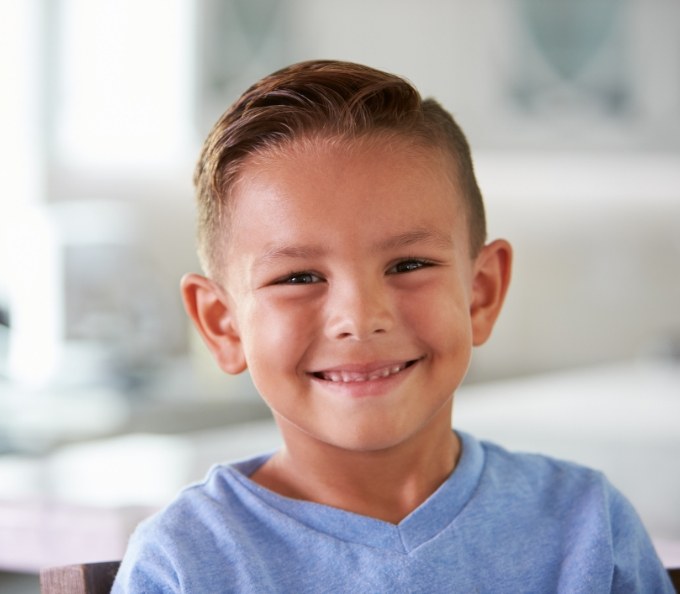 Young boy in blue shirt smiling