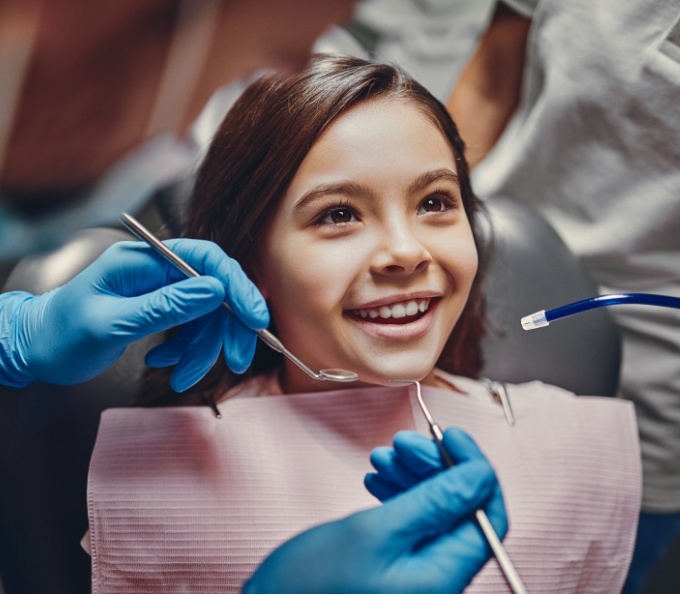 Young girl smiling in dental treatment chair