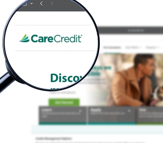 Magnifying glass showing CareCredit logo on their website