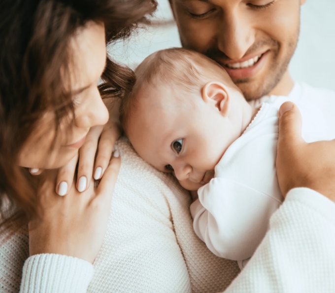 Mother and father holding their baby