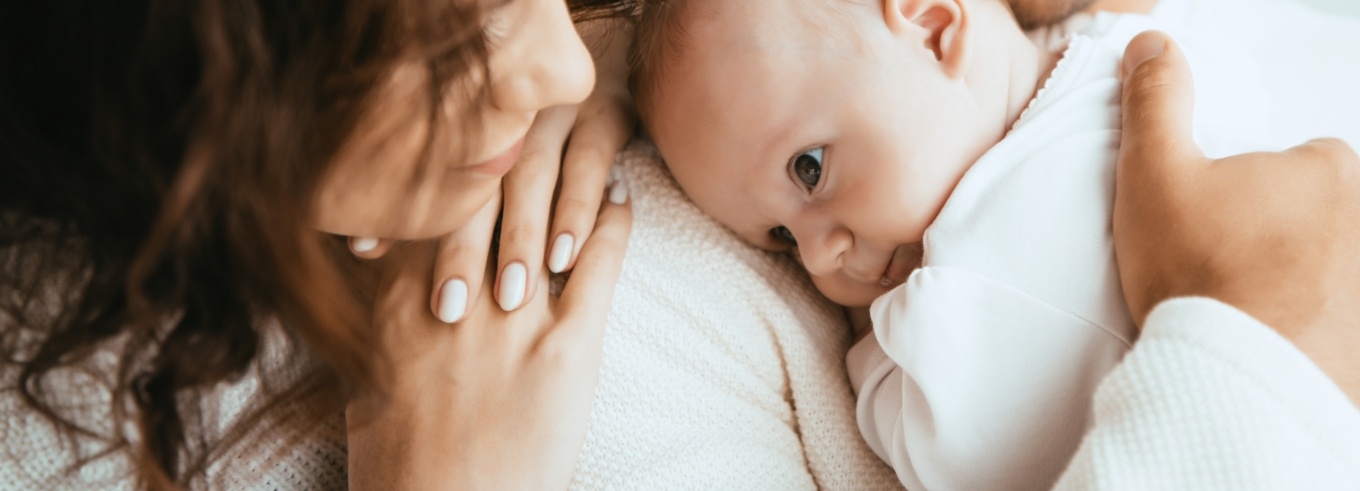 Smiling mother holding her baby