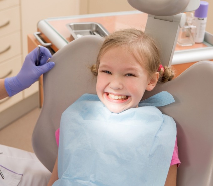 Young girl grinning in dental treatment chair