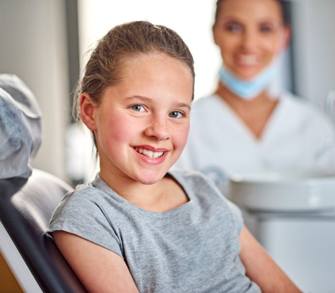 Young child smiling in dental chair after laser frenectomy in Southampton