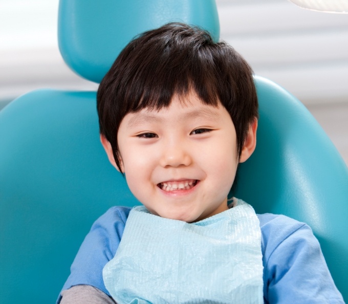 Young boy smiling in dental chair