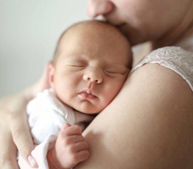 Mother holding her sleeping infant