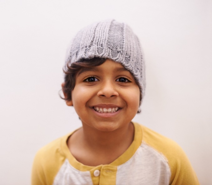 Smiling child in gray beanie